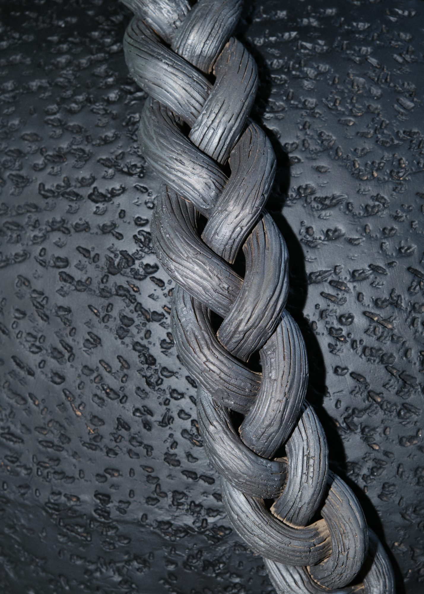 Detail — braided iron texture on ceramic surface