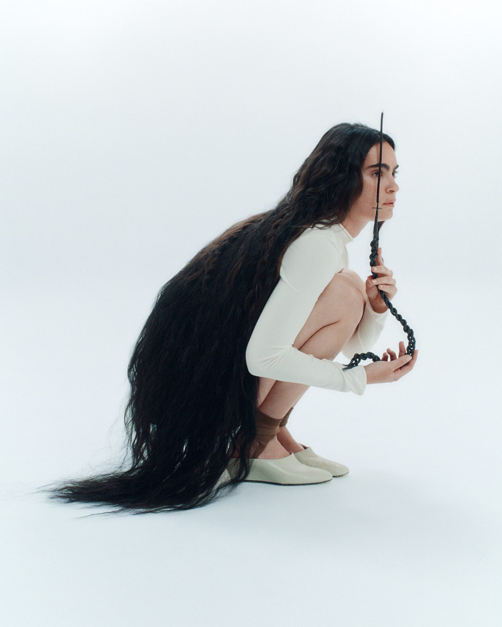 Model with braided iron candelabra