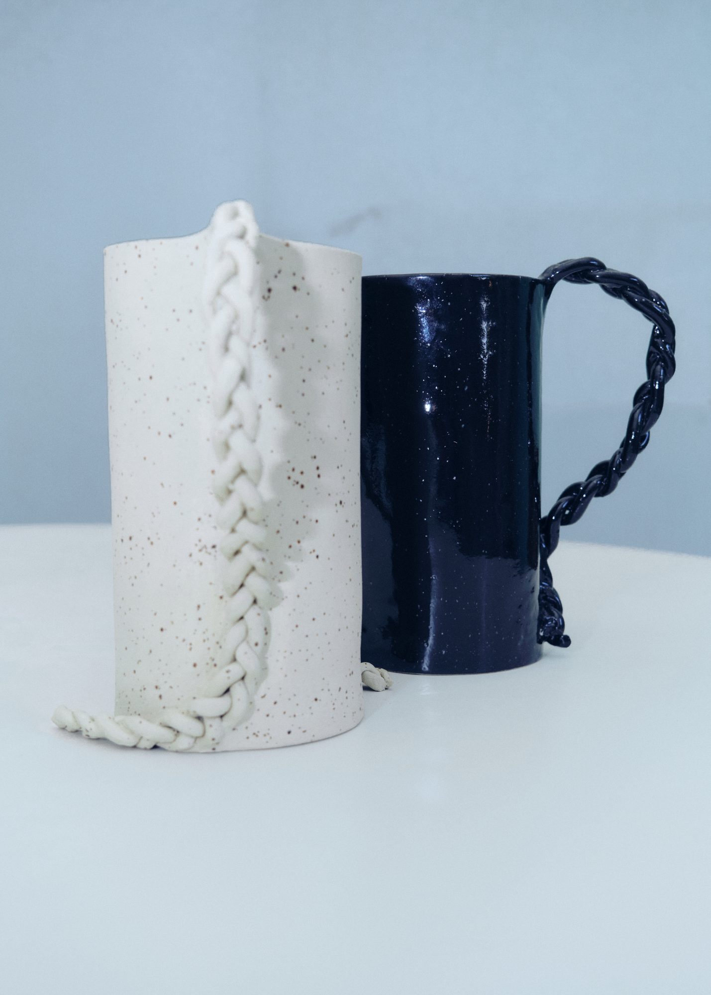 Ceramic jugs with braided handles — white speckled and cobalt blue glaze