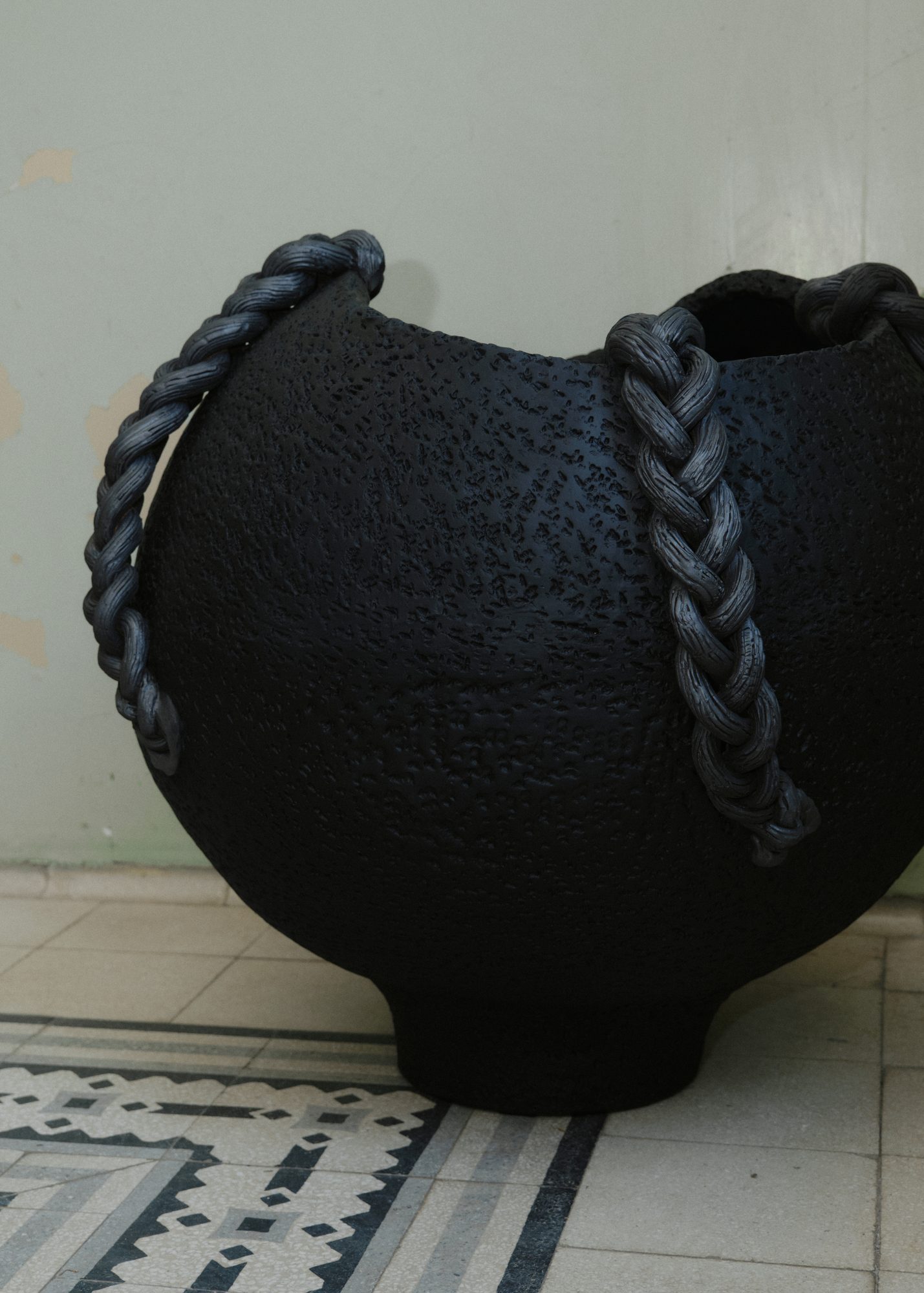 Ceramic vessel with braided iron handles