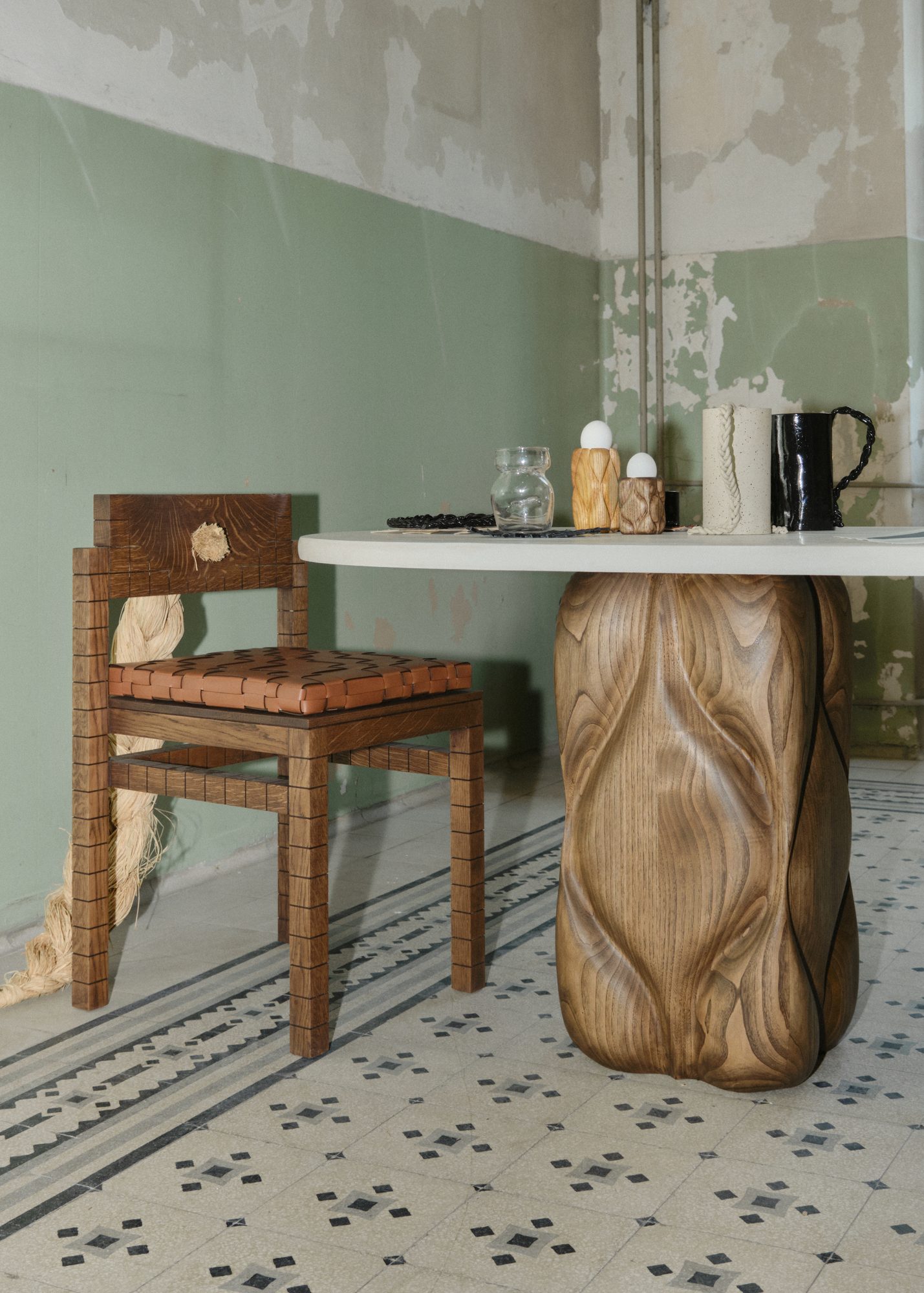 Hand-carved oak table leg and chair with woven leather seat